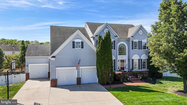 1005 Chaff Way, La Plata, MD 20646 - traditional-style home with a front yard, brick siding, concrete driveway, an attached garage, and fence