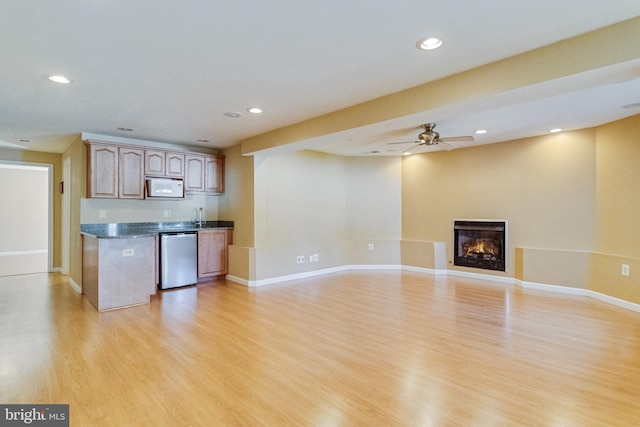 1005 Chaff Way, La Plata, MD 20646 - kitchen with dark countertops, a glass covered fireplace, light wood-type flooring, dishwasher, and white microwave