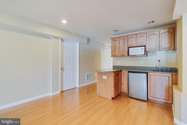 1005 Chaff Way, La Plata, MD 20646 - kitchen with white microwave, light wood-style floors, visible vents, a peninsula, and dishwashing machine