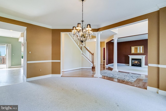 1005 Chaff Way, La Plata, MD 20646 - unfurnished dining area with an inviting chandelier, carpet, a glass covered fireplace, baseboards, and ornate columns