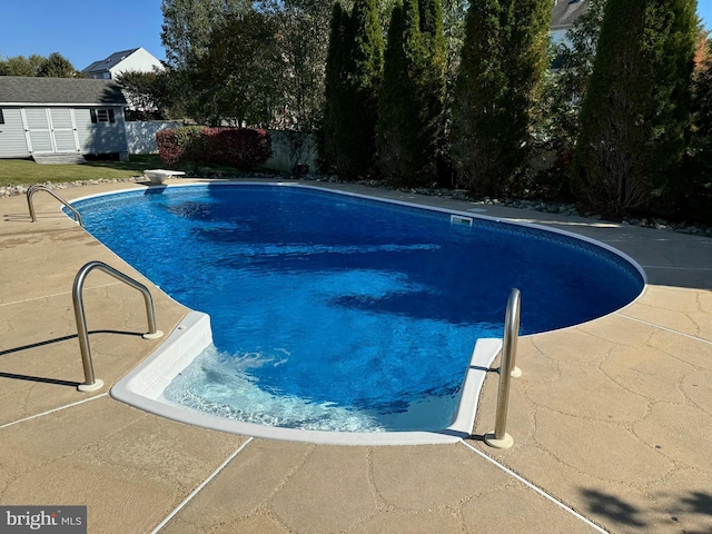 1005 Chaff Way, La Plata, MD 20646 - outdoor pool with fence, an outdoor structure, a diving board, and a patio area