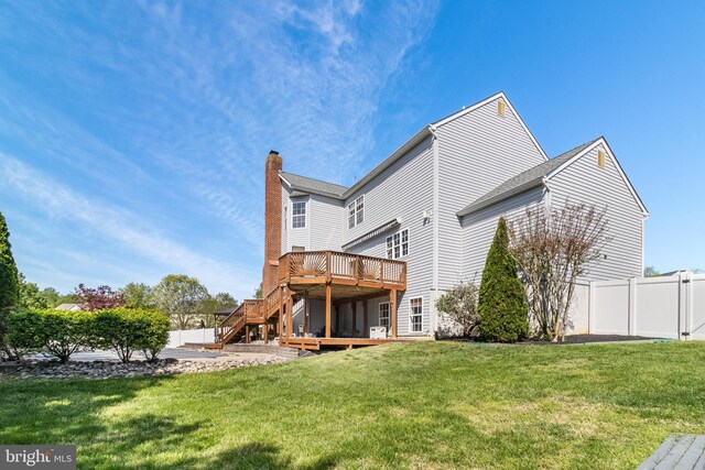 1005 Chaff Way, La Plata, MD 20646 - rear view of property featuring a wooden deck, stairway, a lawn, a chimney, and fence