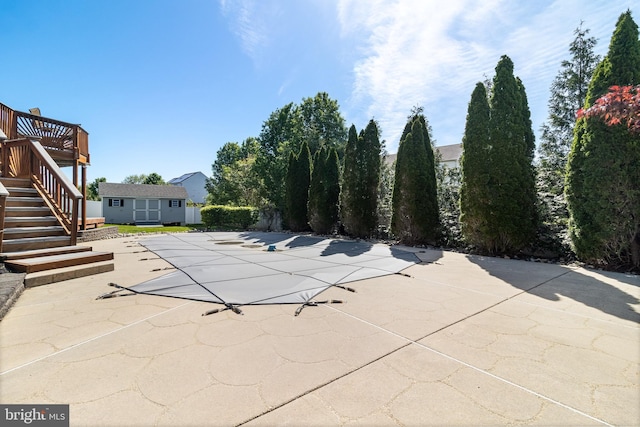 1005 Chaff Way, La Plata, MD 20646 - view of swimming pool featuring a deck, an outdoor structure, a covered pool, a patio area, and stairs