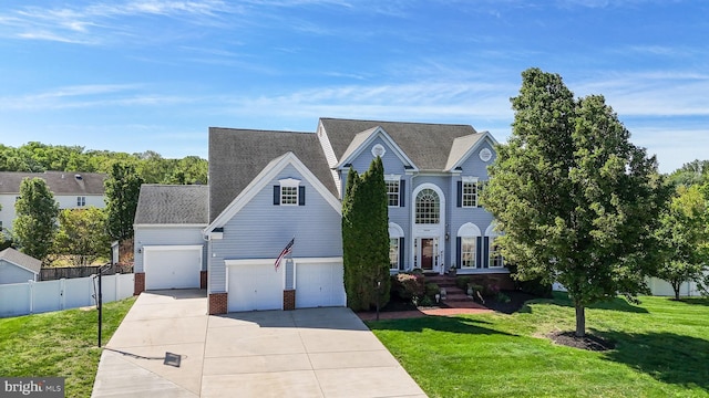 1005 Chaff Way, La Plata, MD 20646 - traditional-style home with fence, concrete driveway, a front yard, and brick siding