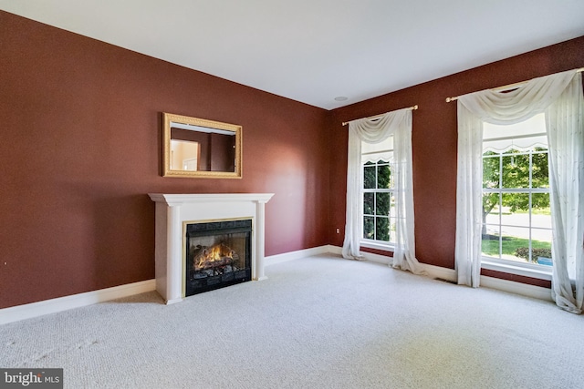 1005 Chaff Way, La Plata, MD 20646 - unfurnished living room featuring baseboards, a lit fireplace, and carpet flooring