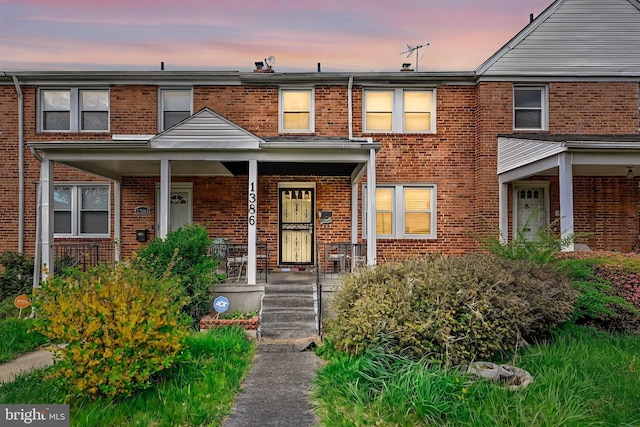 1386 Pentwood Rd, Baltimore, MD 21239 - townhome / multi-family property with brick siding and a porch