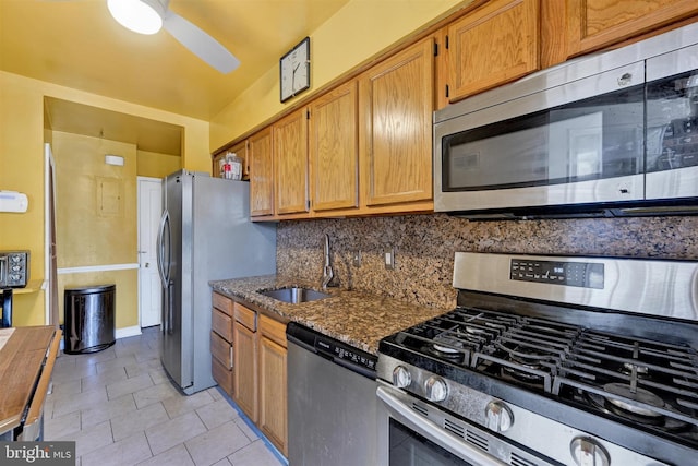 1386 Pentwood Rd, Baltimore, MD 21239 - kitchen featuring stainless steel appliances, a sink, dark stone countertops, backsplash, and ceiling fan