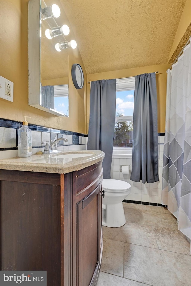 1386 Pentwood Rd, Baltimore, MD 21239 - full bath with tile walls, vanity, a textured ceiling, and toilet