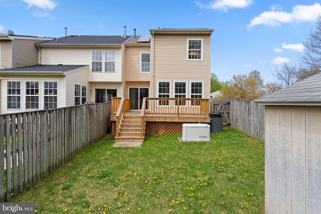 rear view of property with roof mounted solar panels, a fenced backyard, a yard, and central air condition unit