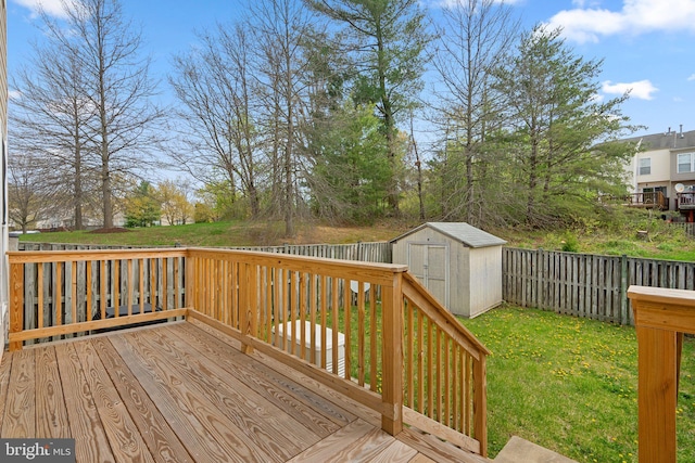 deck featuring a fenced backyard, an outdoor structure, a storage shed, and a yard