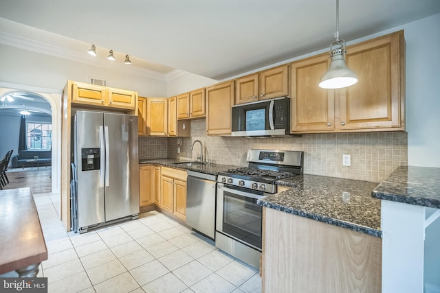 kitchen featuring appliances with stainless steel finishes, a sink, light tile patterned flooring, crown molding, and pendant lighting