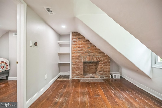 bonus room with wood-type flooring, lofted ceiling, and baseboards