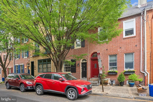 townhome / multi-family property with brick siding