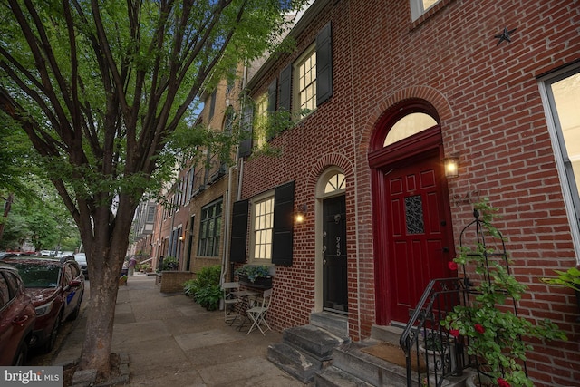 doorway to property with brick siding