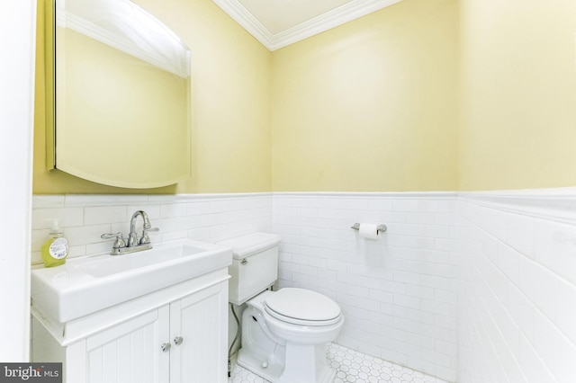 2202 E Cumberland St, Philadelphia, PA 19125 - bathroom featuring wainscoting, vanity, tile walls, toilet, and ornamental molding