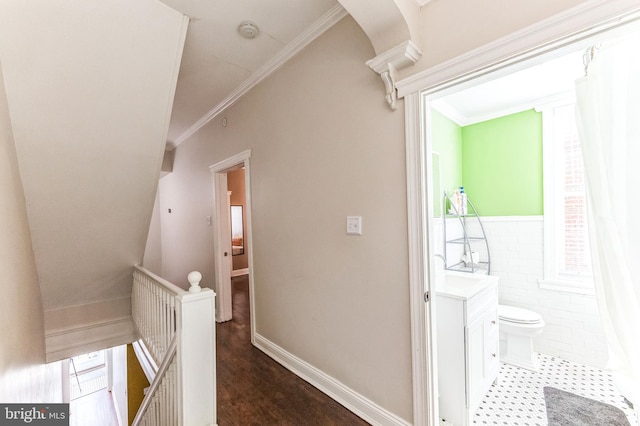 2202 E Cumberland St, Philadelphia, PA 19125 - hallway with ornamental molding, a wainscoted wall, an upstairs landing, and tile walls