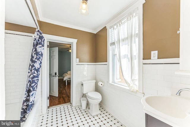 2202 E Cumberland St, Philadelphia, PA 19125 - bathroom featuring shower / bath combo, a sink, toilet, tile walls, and tile patterned flooring