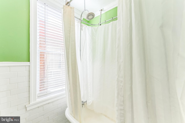 2202 E Cumberland St, Philadelphia, PA 19125 - bathroom with wainscoting, a wealth of natural light, a shower with shower curtain, and tile walls