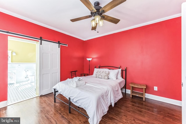 2202 E Cumberland St, Philadelphia, PA 19125 - bedroom featuring a barn door, crown molding, wood finished floors, baseboards, and ensuite bath