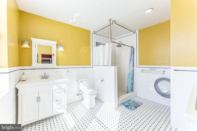 2202 E Cumberland St, Philadelphia, PA 19125 - bathroom with wainscoting, tiled shower, toilet, and tile walls