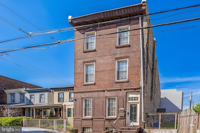 2202 E Cumberland St, Philadelphia, PA 19125 - view of front of property featuring brick siding, entry steps, and fence