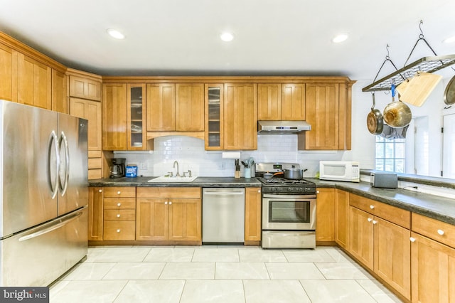 2202 E Cumberland St, Philadelphia, PA 19125 - kitchen with backsplash, appliances with stainless steel finishes, under cabinet range hood, and a sink