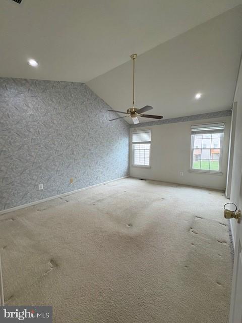 empty room with lofted ceiling, a ceiling fan, carpet floors, wallpapered walls, and recessed lighting