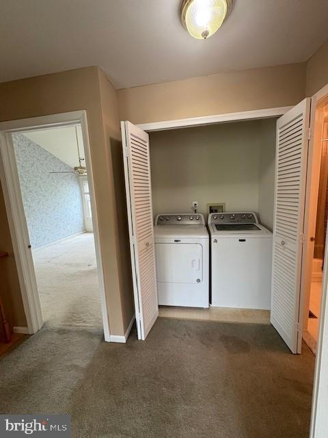 laundry room with independent washer and dryer and dark colored carpet