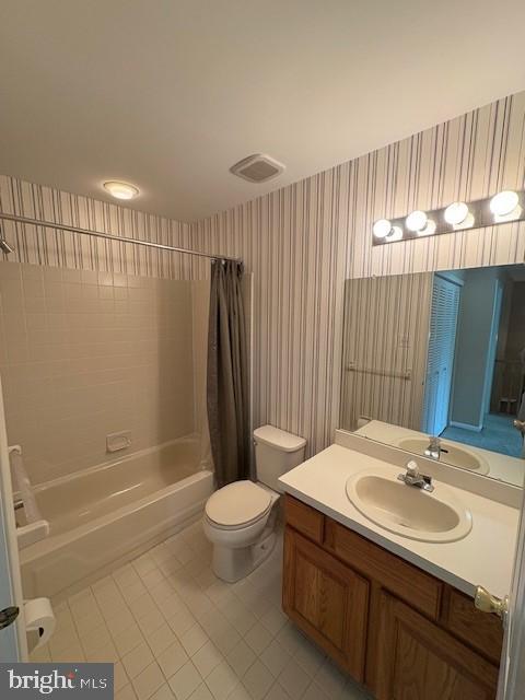 bathroom featuring wallpapered walls, tile patterned flooring, toilet, shower / bath combination with curtain, and vanity