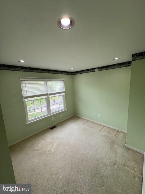 empty room with recessed lighting, baseboards, and light colored carpet