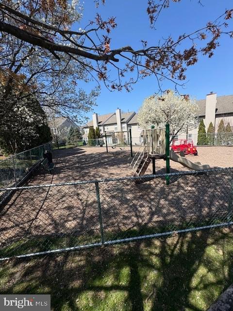 community play area with fence and a residential view