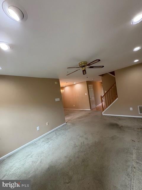 basement featuring baseboards, ceiling fan, stairway, recessed lighting, and carpet