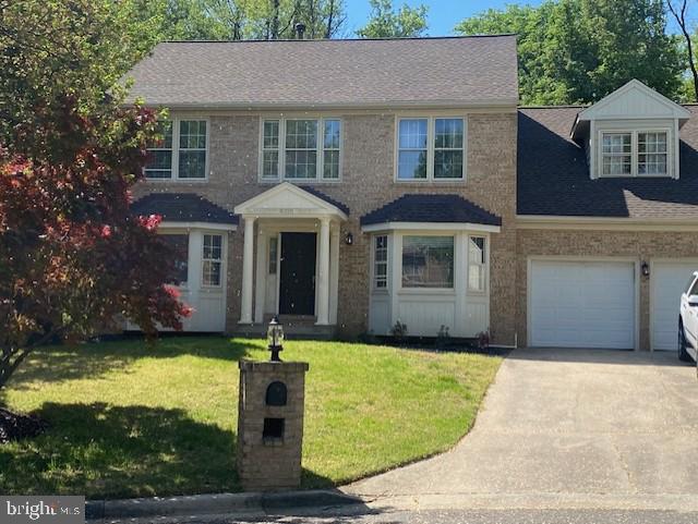 4016 Ayden Ct, Bowie, MD 20721 - view of front facade featuring driveway, a front lawn, a garage, and roof with shingles
