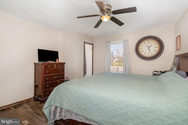 bedroom with baseboards, a ceiling fan, and wood finished floors