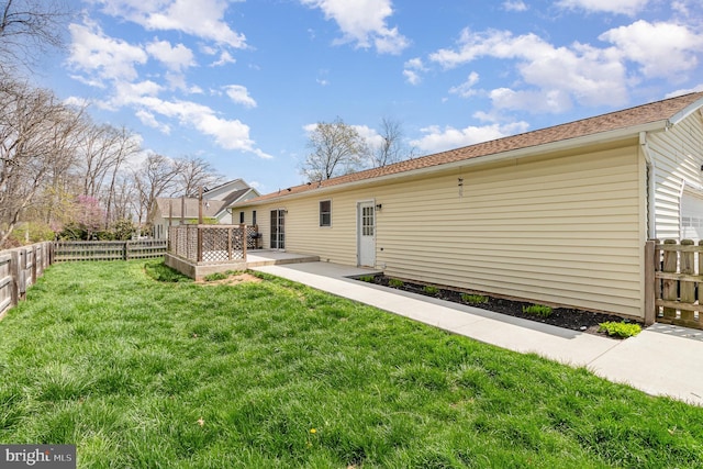 back of house with a lawn, a patio, and a fenced backyard