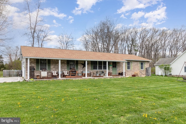 single story home with brick siding, a porch, and a front lawn