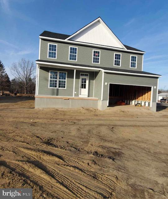 view of front facade with an attached garage and covered porch