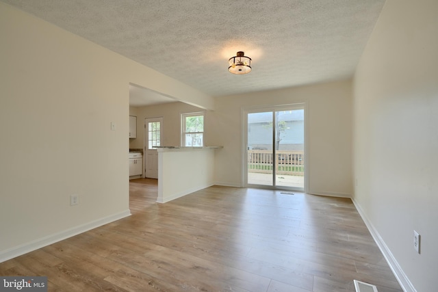 4504 E Joppa Rd, Perry Hall, MD 21128 - empty room featuring a textured ceiling, baseboards, and light wood-style floors
