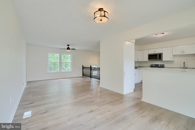 4504 E Joppa Rd, Perry Hall, MD 21128 - kitchen with appliances with stainless steel finishes, visible vents, light wood-style flooring, and white cabinetry