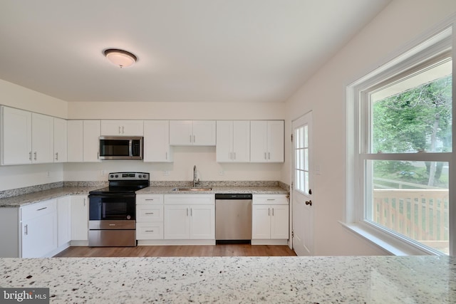 4504 E Joppa Rd, Perry Hall, MD 21128 - kitchen with white cabinetry, stainless steel appliances, and a sink