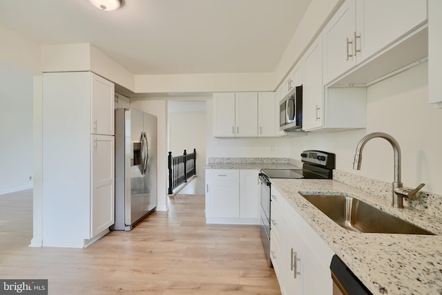 4504 E Joppa Rd, Perry Hall, MD 21128 - kitchen with white cabinetry, stainless steel appliances, light wood-style flooring, and a sink