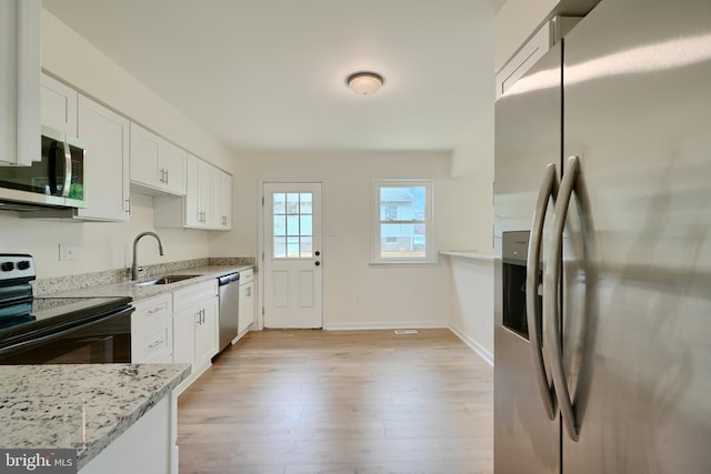 4504 E Joppa Rd, Perry Hall, MD 21128 - kitchen featuring a sink, white cabinets, light stone countertops, baseboards, and appliances with stainless steel finishes