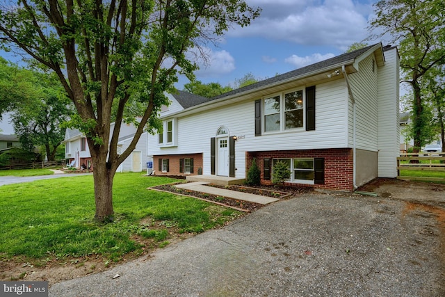 4504 E Joppa Rd, Perry Hall, MD 21128 - raised ranch featuring brick siding, a front lawn, and fence