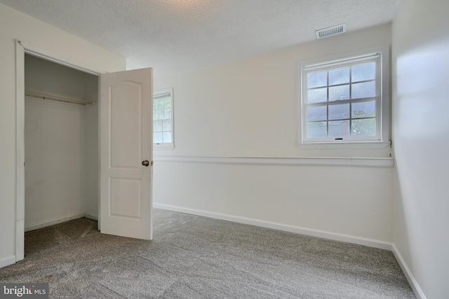 4504 E Joppa Rd, Perry Hall, MD 21128 - unfurnished bedroom featuring a textured ceiling, multiple windows, and carpet floors