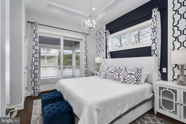 bedroom featuring a tray ceiling, baseboards, a notable chandelier, dark wood-style floors, and recessed lighting