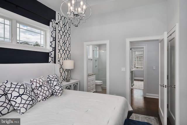 bedroom with a chandelier, wood finished floors, ensuite bath, and baseboards