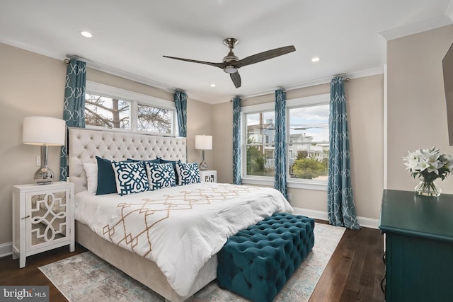 bedroom featuring wood finished floors, crown molding, baseboards, and multiple windows