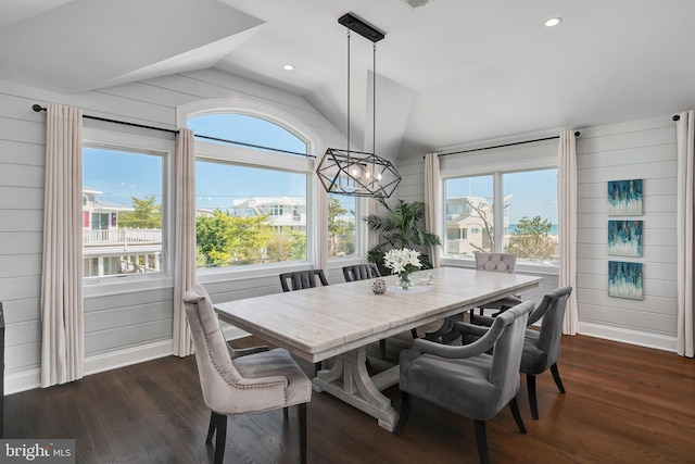 dining space featuring a chandelier, lofted ceiling, dark wood-type flooring, and plenty of natural light