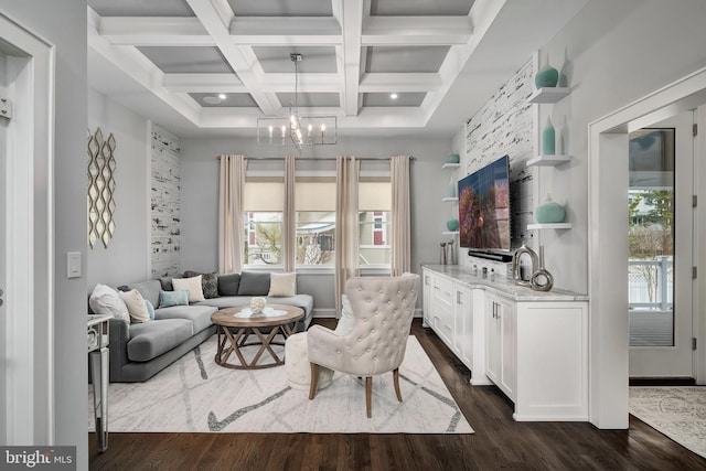 living room with a chandelier, dark wood finished floors, plenty of natural light, and beam ceiling