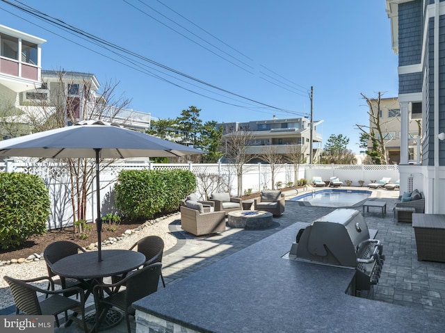 view of patio / terrace featuring a fenced backyard, a fenced in pool, an outdoor living space with a fire pit, and a grill